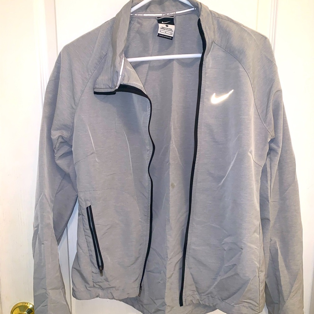 Small grey Nike windbreaker jacket.